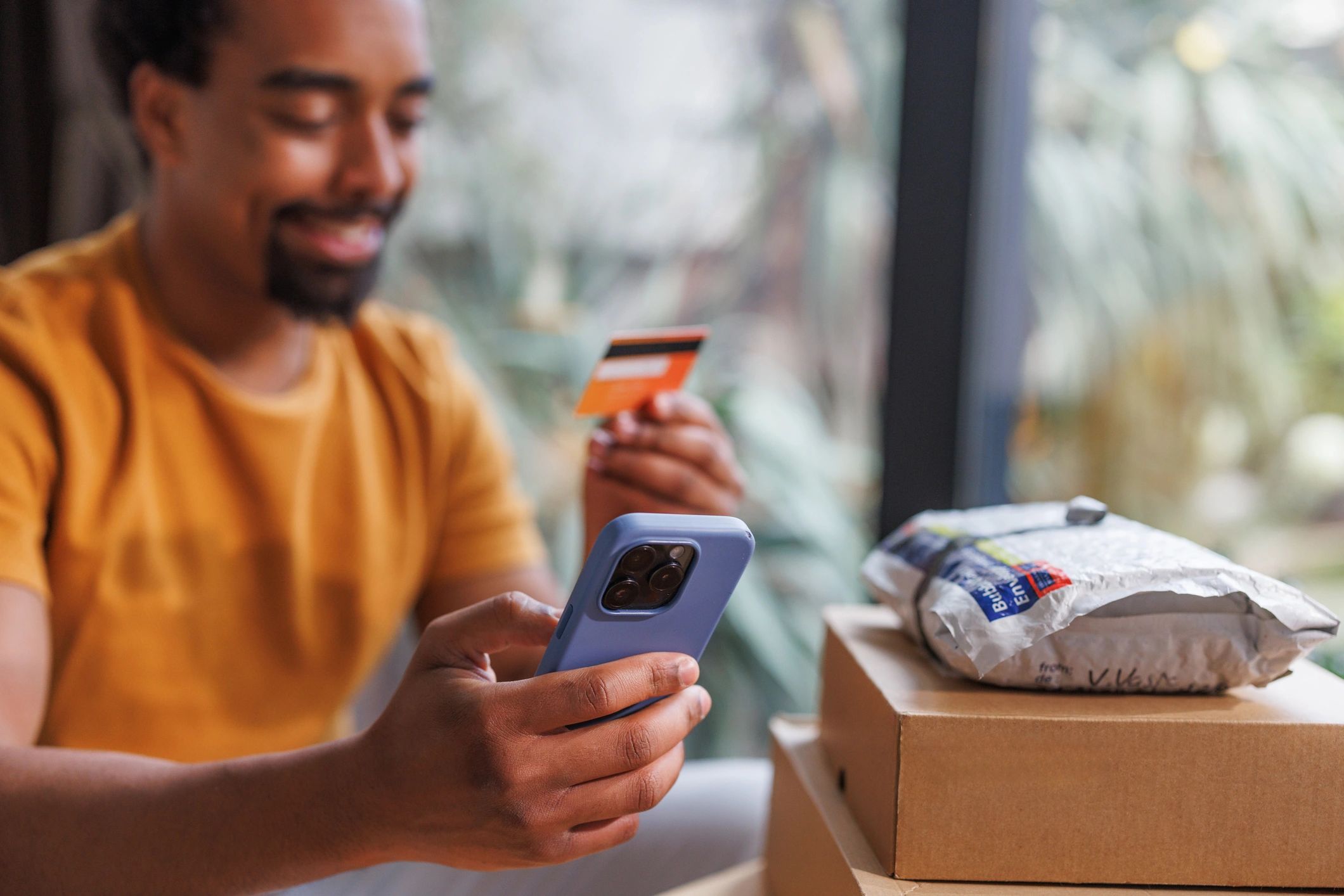 Customer shopping online with a smartphone and payment card
