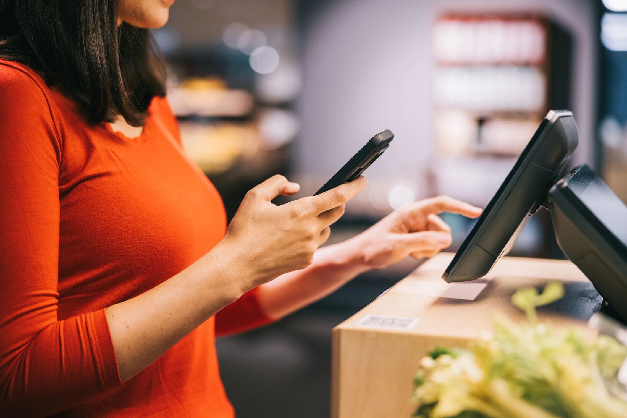 Person paying with a smartphone at a self-service terminal